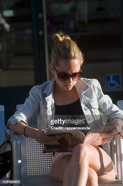 reading a magazine - west hollywood california stock pictures, royalty-free photos & images