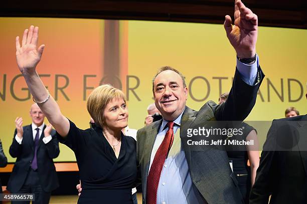 First Minister of Scotland Alex Salmond, acknowledges applause with Nicola Sturgeon following his last key note speech as party leader of the SNP at...