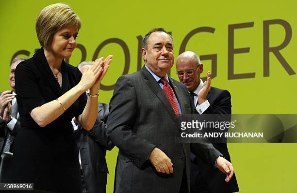 New SNP party leader Nicola Sturgeon applauds as Scotland's First Minister Alex Salmond delivers his final speech as the leader of the Scottish...
