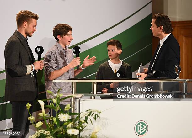 Flrorian Trinks, Benjamin Jaeger and Till Bartlog react during the Club 100/Fair ist mehr Award Ceremony at Rathaus Nuernberg on November 14, 2014 in...