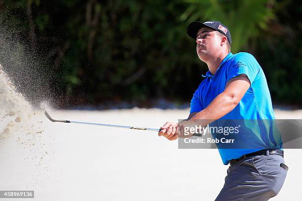 Michael Putnam of the United States hits a shot out of a bunker on the 16th hole during the second round of the OHL Classic at Mayakoba on November...