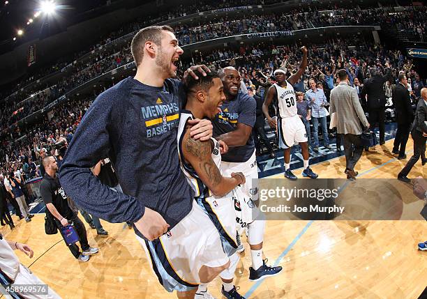 Jon Leuer of the Memphis Grizzlies congratulates and celebrates with Courtney Lee after he hit the winning shot against the Sacramento Kings on...