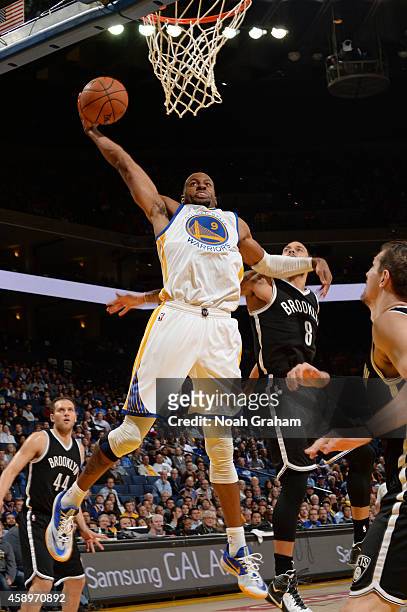 Andre Iguodala of the Golden State Warriors goes in for the dunk against the Brooklyn Nets on November 13, 2014 at Oracle Arena in Oakland,...