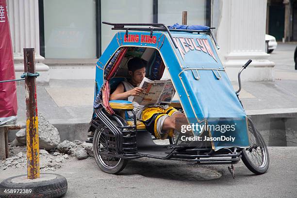 cab driver reads newspaper - filipino tricycle stock pictures, royalty-free photos & images