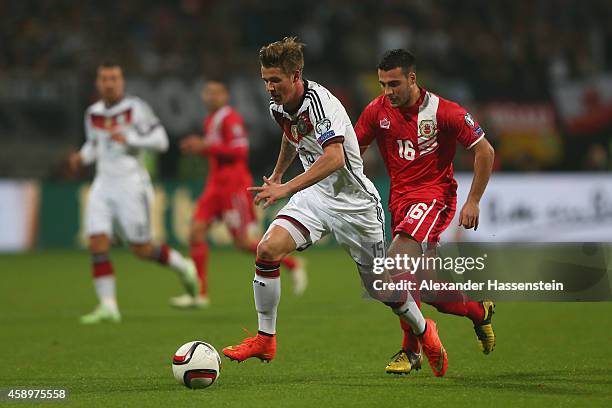 Erik Durm of Germany battles for the ball with Brian Perez of Gibraltar during the EURO 2016 Group D Qualifier match between Germany and Gibraltar at...