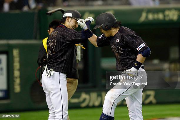 Nobuhiro Matsuda of Samurai Japan is greeted by teammate Hikaru Ito after hitting a home run in the eighth inning during the game against the MLB...