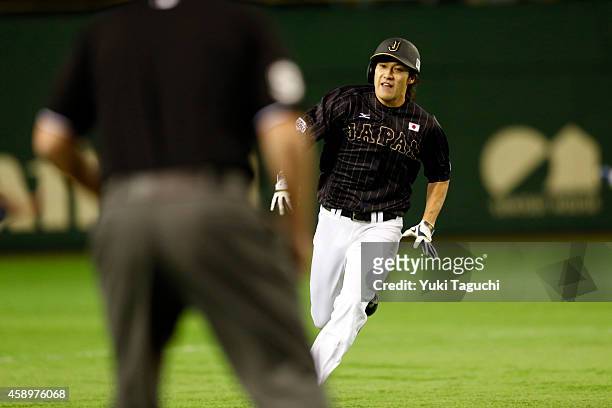 Yuki Yanagita of Samurai Japan hits a two-run RBI triple in the second inning during the game against the MLB All-Stars at the Tokyo Dome during the...