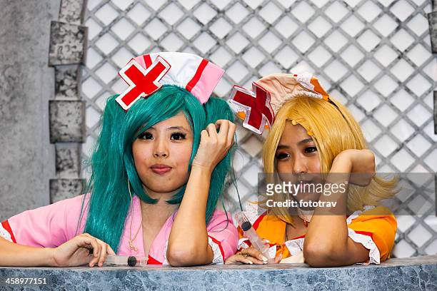asian girls playing cosplay - cosplay stockfoto's en -beelden