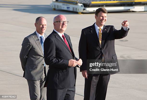 Queensland Premier Campbell Newman, Attorney-General for Australia George Brandis and US ambassador to Australia John Berry wait on the tarmac at...