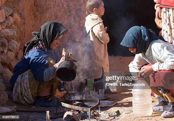berber woman making tea - todra gorge stock pictures, royalty-free photos & images
