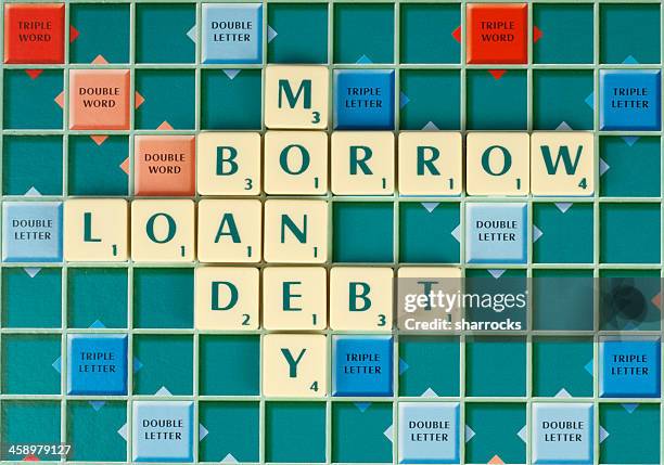 borrowing money is bad - scrabble stock pictures, royalty-free photos & images