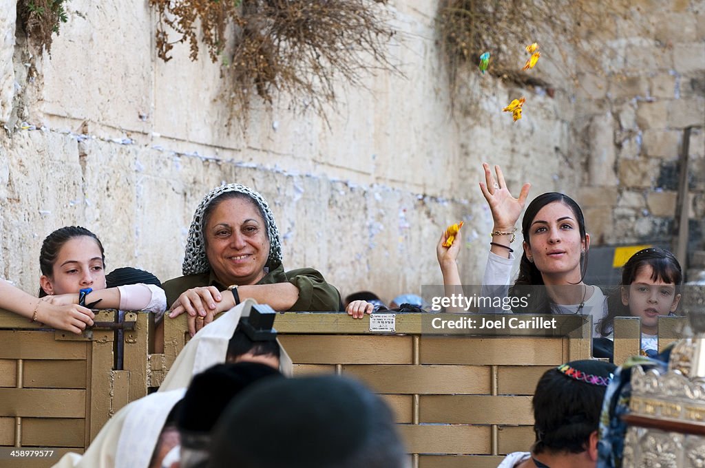 Throwing candy at bar mitzvah by Western Wall