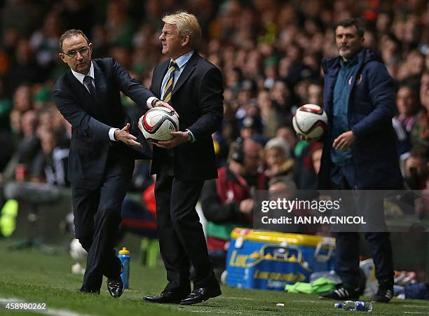 Scotland's manager Gordon Strachan and Republic of Ireland's manager Martin O'Neill vie for the ball as Republic of Ireland's assistant manager Roy...