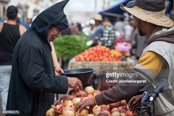 essaouira, morocco: buying pomegranates - nicolamargaret stock pictures, royalty-free photos & images