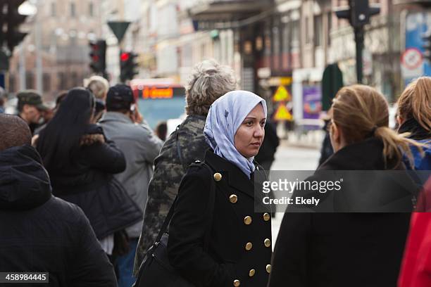 people at a bus stop. - hijab stock pictures, royalty-free photos & images