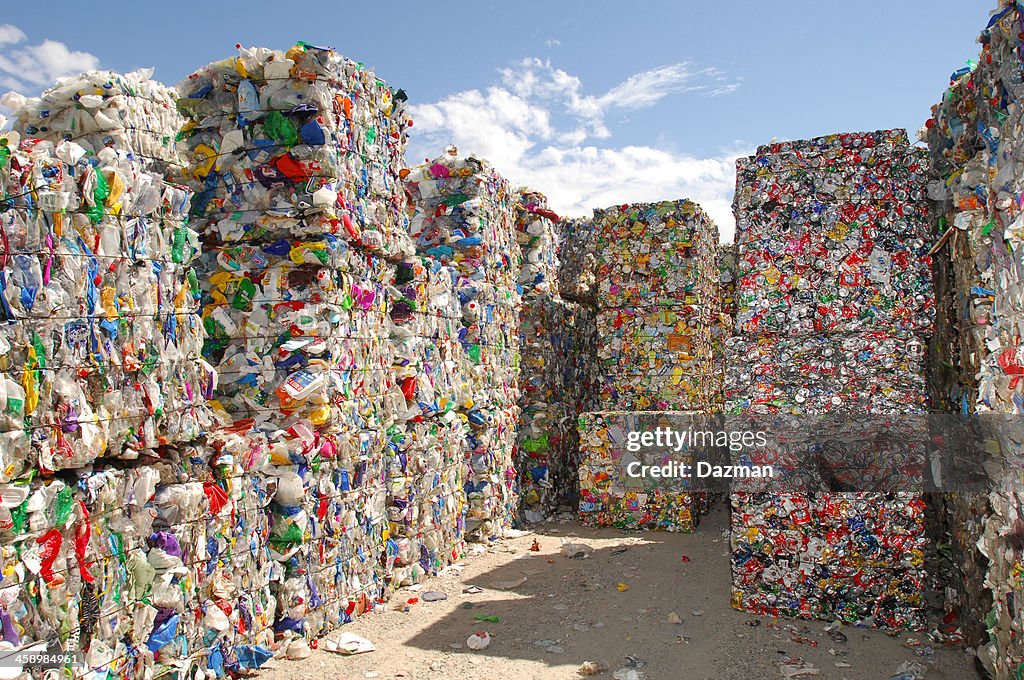 Crushed plastic and aluminium containers for waste disposal.