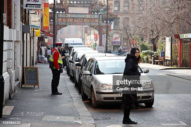 traffic warden in manchester city centre street - traffic control stock pictures, royalty-free photos & images