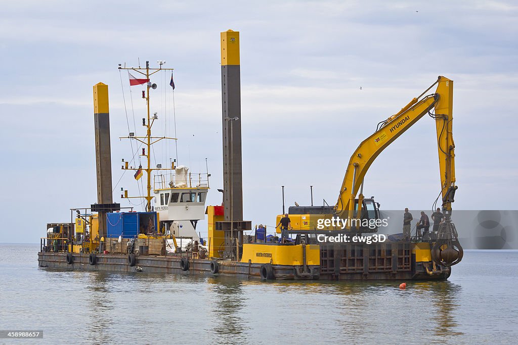 Industrial Barge with an Excavator on the Sea