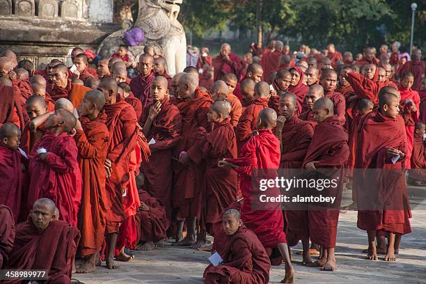 myanmar: line of monks at bagan new year's festival - theravada stock pictures, royalty-free photos & images