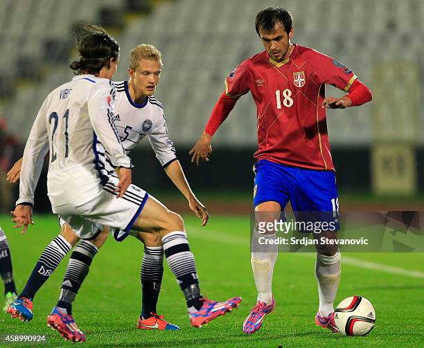 Danko Lazovic of Serbia in action against Nicolai Boilesen and Lasse Vibe of Denmark during the Euro 2016 group I qualifying football match between...