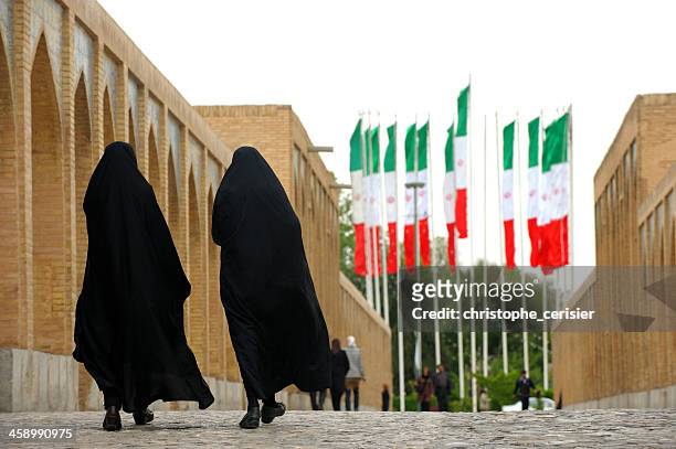 women in nitjab and iran flags - iran women stock pictures, royalty-free photos & images