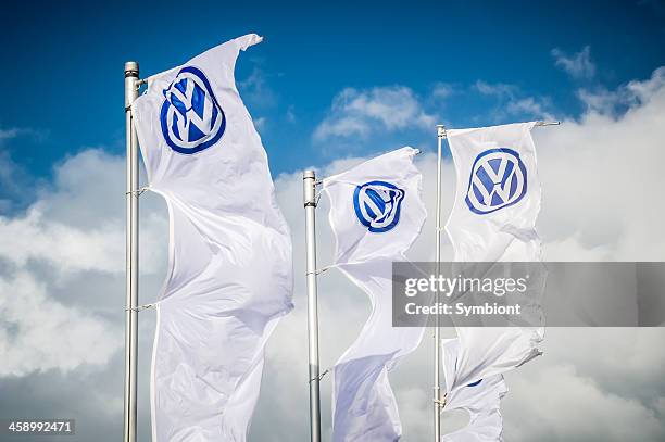 three volkswagen flags in the wind - volkswagen stockfoto's en -beelden