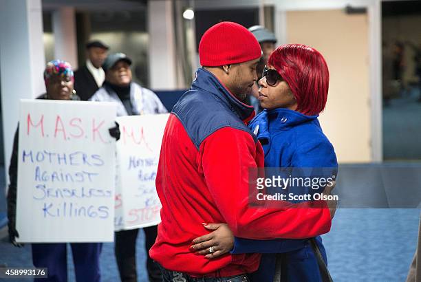 Michael Browns mother Lesley McSpadden is greeted by her husband Louis Head after arriving at St. Louis International Airport from Geneva,...