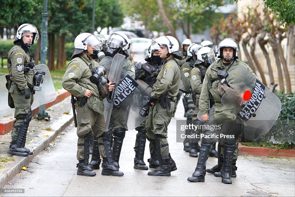 Riot police officers stand outside the Athens Polytechnic.