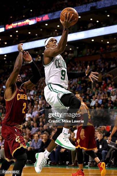 Rajon Rondo of the Boston Celtics drives to the basket against Kyrie Irving of the Cleveland Cavaliers in the first half at TD Garden on November 14,...