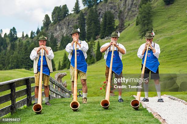 musicians playing alphorn - woodwind instrument stock pictures, royalty-free photos & images