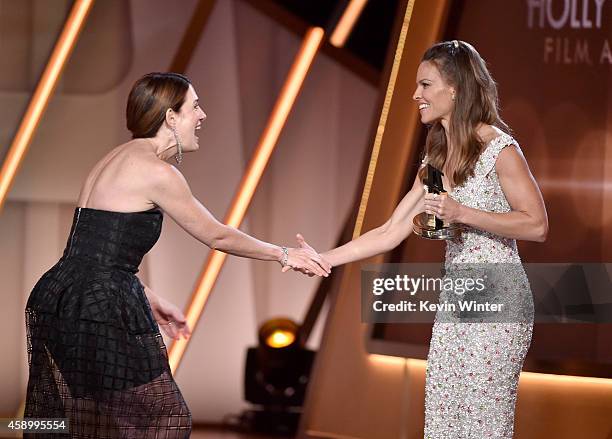 Writer Gillian Flynn accepts the Hollywood Screenwriter Award for 'Gone Girl' from actress Hilary Swank onstage during the 18th Annual Hollywood Film...