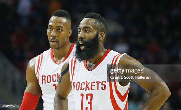 James Harden and Dwight Howard of the Houston Rockets wait on the court during the game against the Philadelphia 76ers at the Toyota Center on...