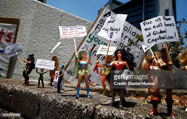 Figurines hold small banners during a protest against G20 leaders on November 15, 2014 in Brisbane, Australia. World leaders have gathered in...