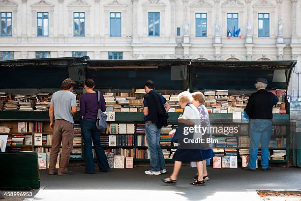 stand with vintage books, posters, advertisements and souvenirs in paris - french literature stock pictures, royalty-free photos & images