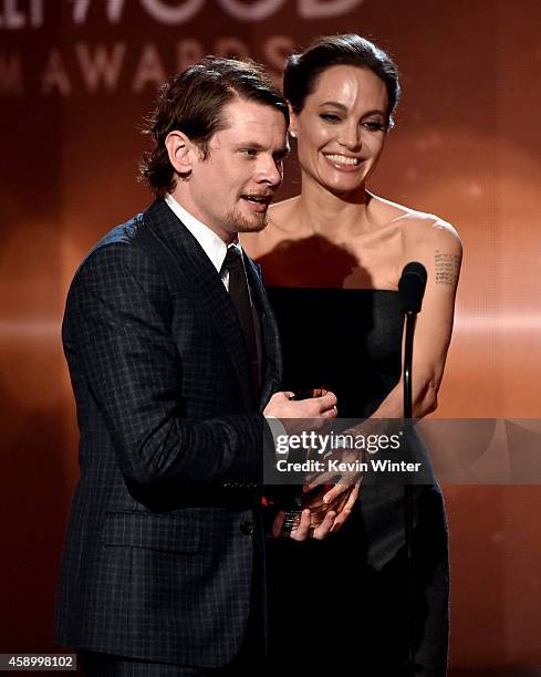 Actor Jack O'Connell accepts the New Hollywood Award for 'Unbroken' from actress Angelina Jolie onstage during the 18th Annual Hollywood Film Awards...