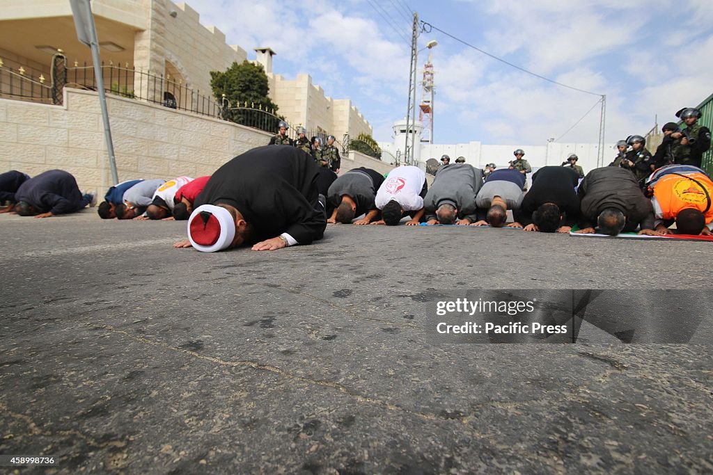 Palestinians perform Friday prayers on the northern barrier...