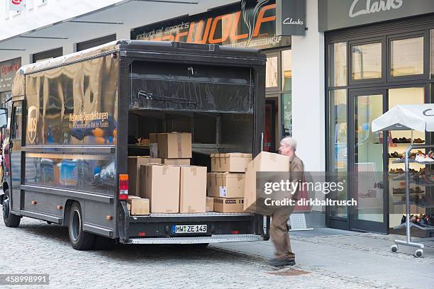 driver of an ups-car loading big parcel - ups stock pictures, royalty-free photos & images