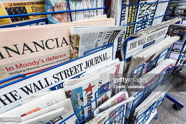 economy newspapers on a newsstand - krantenkiosk stockfoto's en -beelden