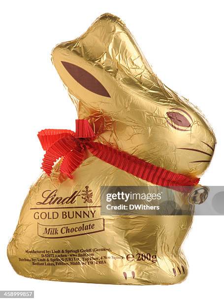 lindt easter gold bunny isolated on white - chocolate bunny stock pictures, royalty-free photos & images