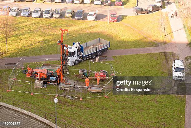 three men drilling borehole with mobile rig - borehole stock pictures, royalty-free photos & images