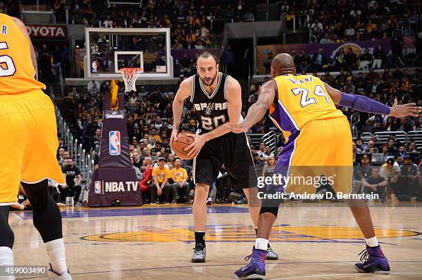 Manu Ginobili of the San Antonio Spurs handles the ball against Kobe Bryant of the Los Angeles Lakers on November 14, 2014 at Staples Center in Los...