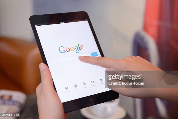google on ipad mini - voice search stock pictures, royalty-free photos & images