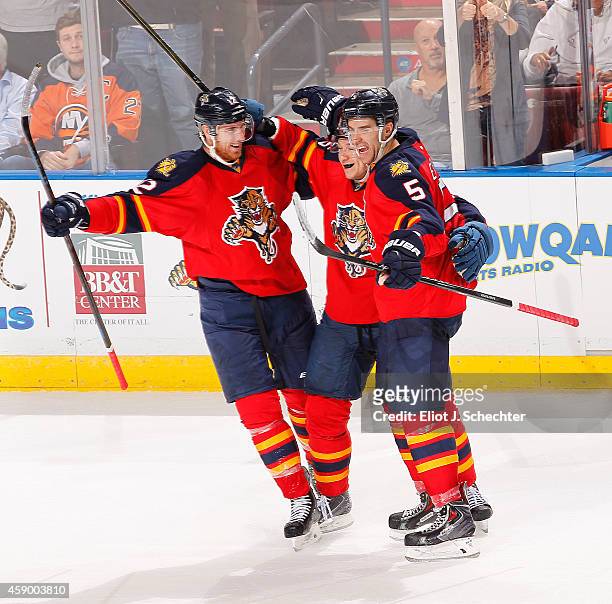 Aaron Ekblad of the Florida Panthers celebrates his goal with teammates Jussi Jokinen and Jimmy Hayes against the New York Islanders at the BB&T...