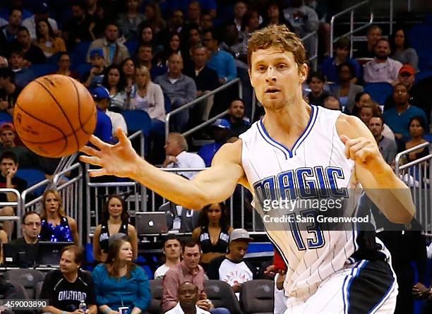 Luke Ridnour of the Orlando Magic attempts a pass during the game against the Milwaukee Bucks at Amway Center on November 14, 2014 in Orlando,...