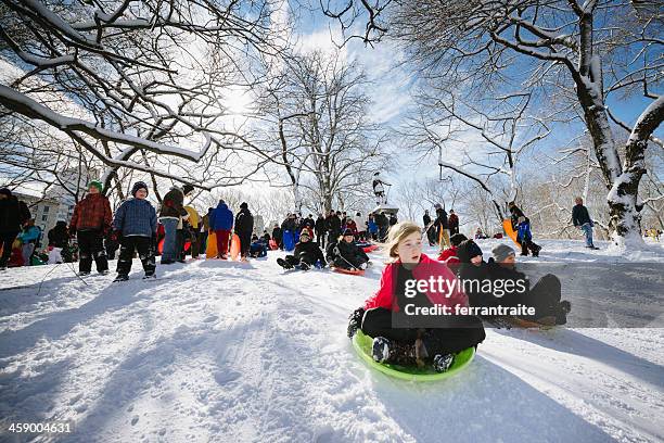 sledding in central park nyc - central park winter stock pictures, royalty-free photos & images