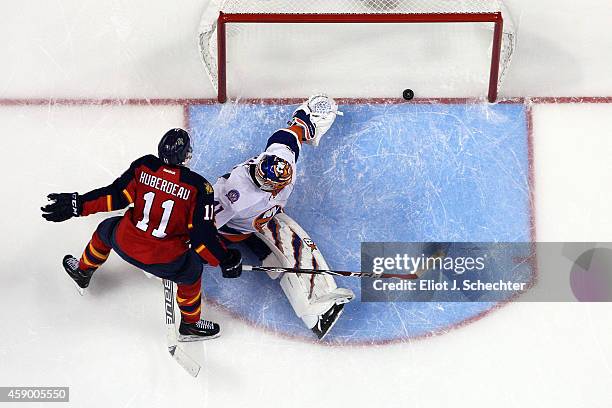 Jonathan Huberdeau of the Florida Panthers scores a goal in the shoot out against Goaltender Jaroslav Halak of the New York Islanders at the BB&T...