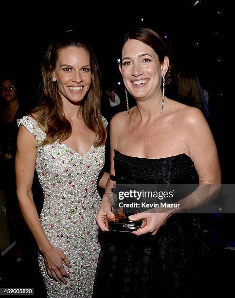 Actress Hilary Swank and writer Gillian Flynn pose with the Hollywood Screenwriter Award for 'Gone Girl' backstage during the 18th Annual Hollywood...