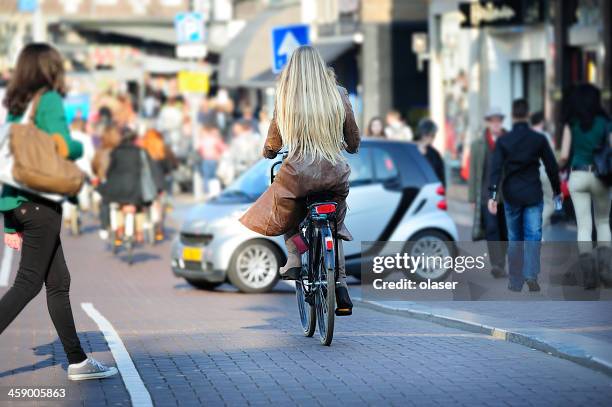 city scene central amsterdam - pedestrian car stock pictures, royalty-free photos & images