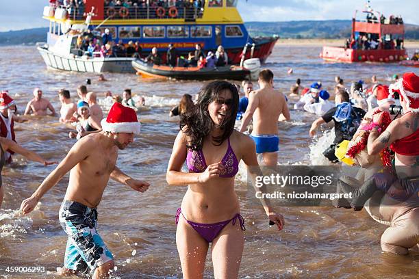 annual christmas day swim:  exmouth, devon, 2012 - nicolamargaret stock pictures, royalty-free photos & images
