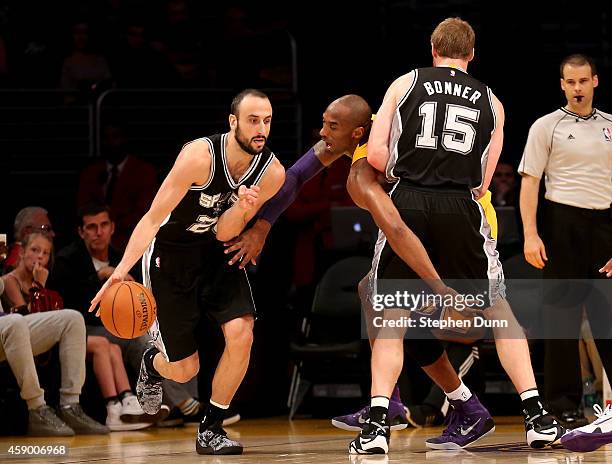 Manu Ginobili of the San Antonio Spurs drives as Kobe Bryant of the Los Angeles Lakers is caught in a screen set by Spur Matt Bonner at Staples...